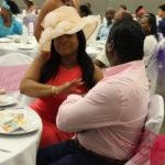 Annual Tea Party 2017 — woman covering face with hat playfully