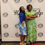 Annual Tea Party 2017 — two women posing at Here's Help backdrop