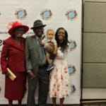 Annual Tea Party 2017 — family posing together at event backdrop
