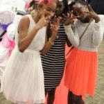 Annual Tea Party 2017 — three young women posing outdoors at event